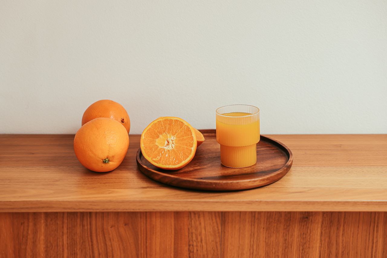 sliced orange and orange juice on tray table